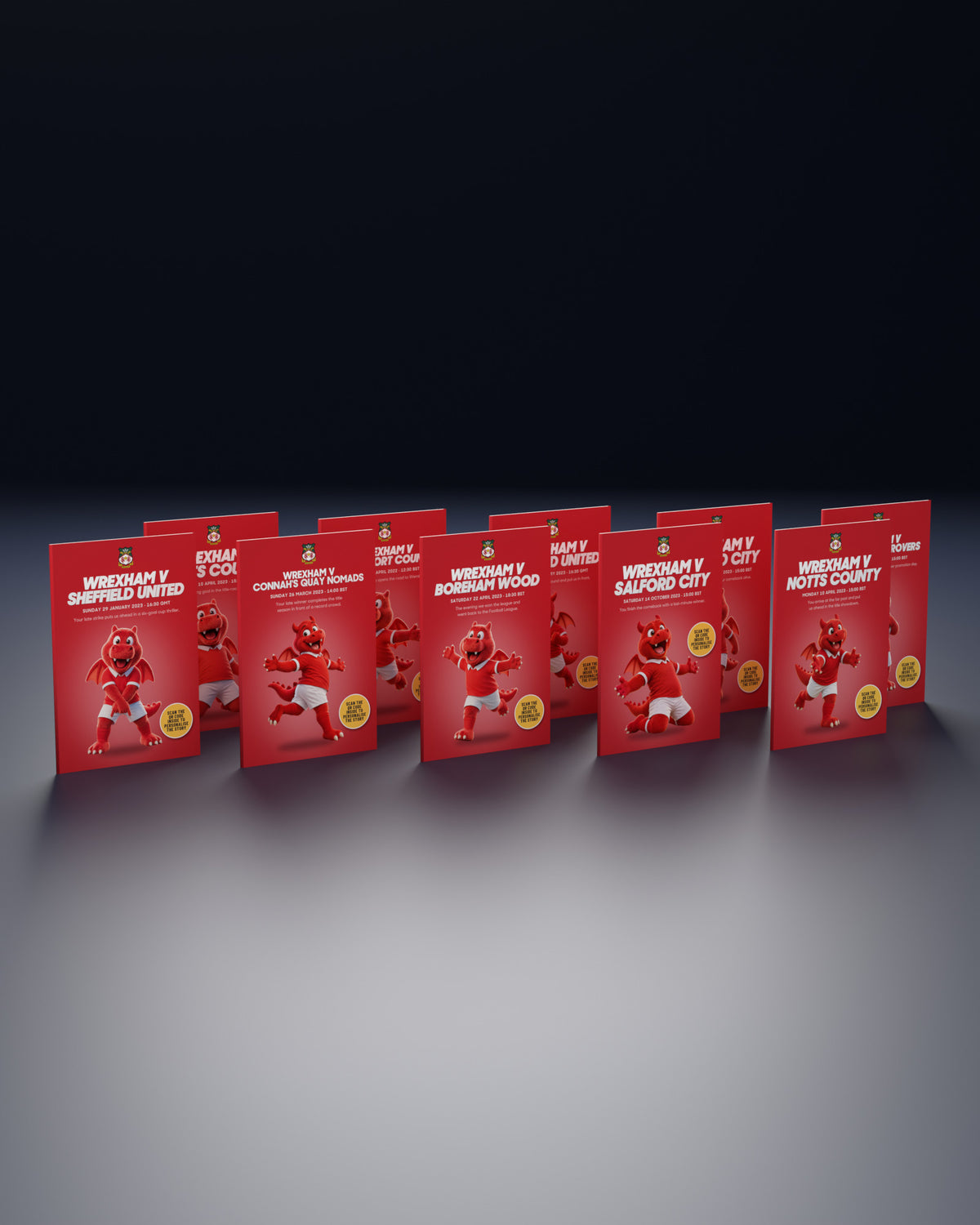 Ten Wrexham Historic Moments books standing in two rows on a navy studio floor, Quick buy edition with Wrex the Dragon on every cover.