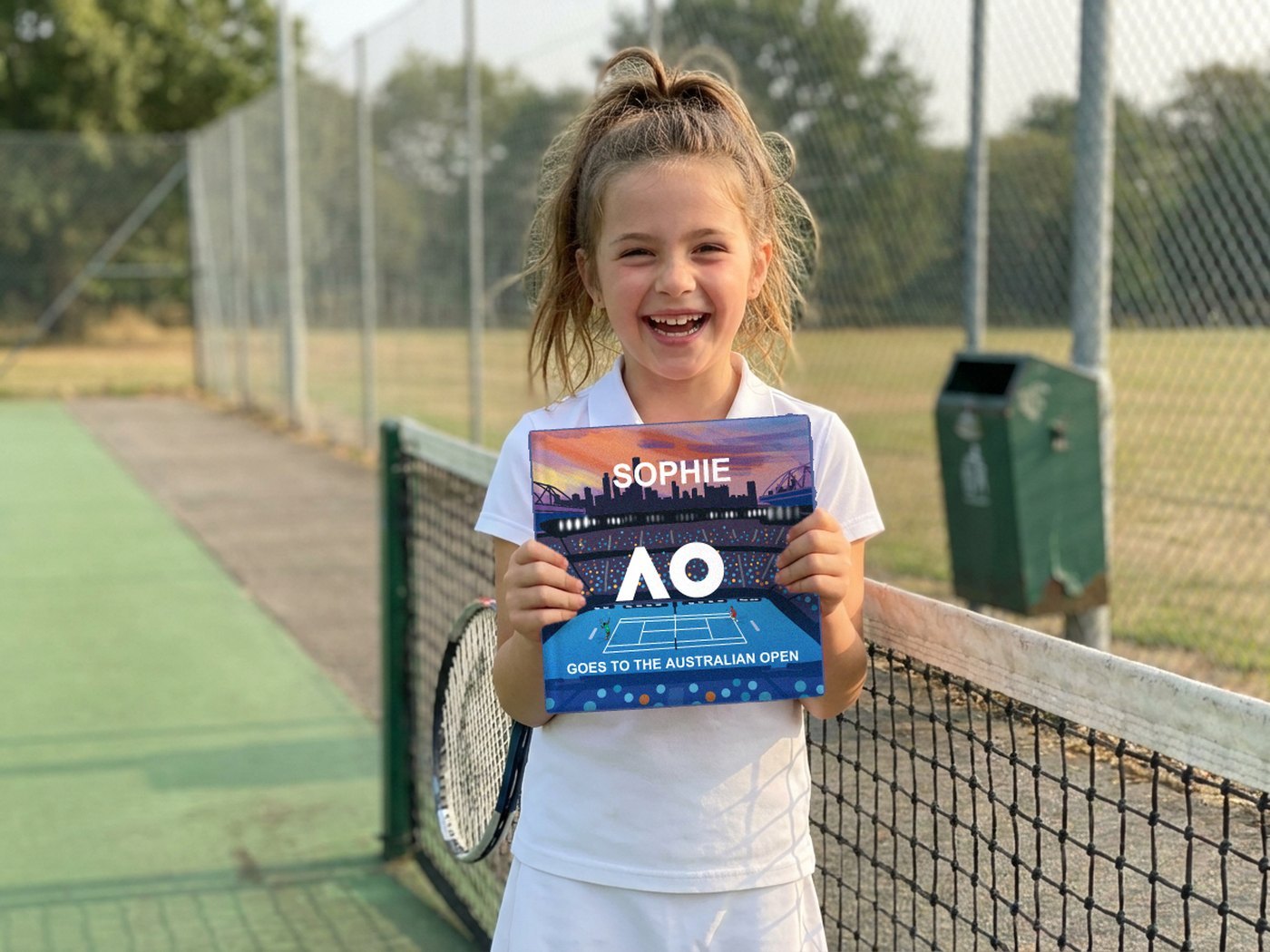 A child holding their personalised YATS storybook